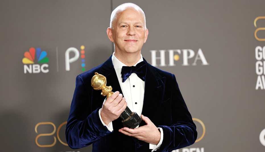 Ryan Murphy holding the Carol Burnett Award in the press room at the 80th Annual Golden Globe Awards