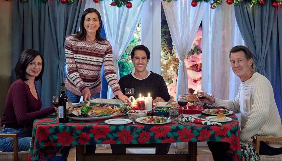 The cast of "Christmas on Cherry Lane" dining together at a dinner table.
