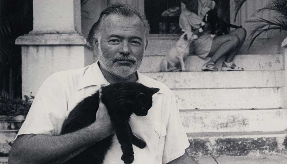 Ernest Hemingway holding a cat at his home in Cuba Ernest Hemingway holding a cat at his home in Cuba