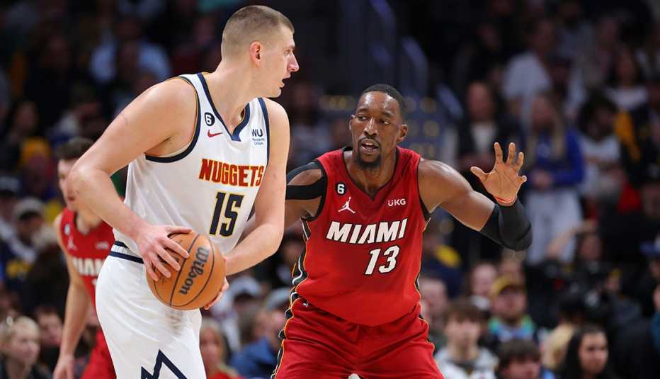 Miami Heat center Bam Adebayo guards Denver Nuggets center Nikola Jokic during the first quarter at Ball Arena in Denver