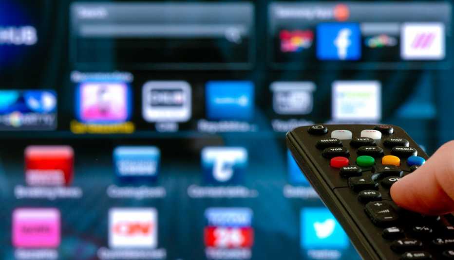 remote pointed at smart tv with streaming app icons