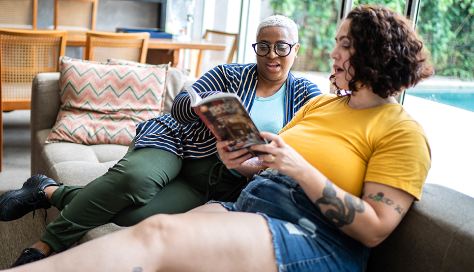 a couple sitting together reading a book