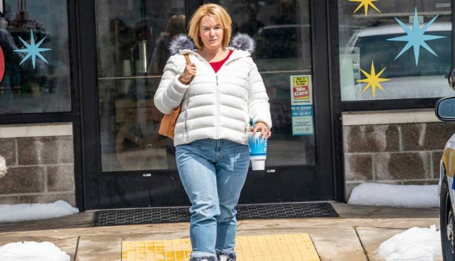 Renee Zellweger walking outside of a convenience store with a large soda in her hand as she stars as Pam Hupp in The Thing About Pam
