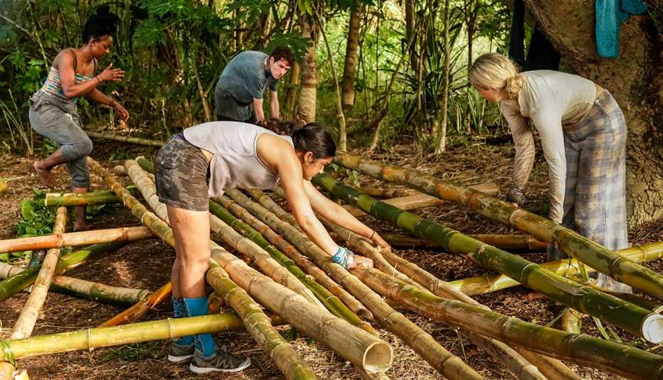 Survivor castaways work together to build shelter during Season 42