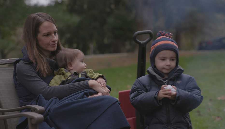 Cheryl Yoder and two of her sons sit by a fire in their yard Cheryl Yoder and two of her sons sit by a fire in their yard