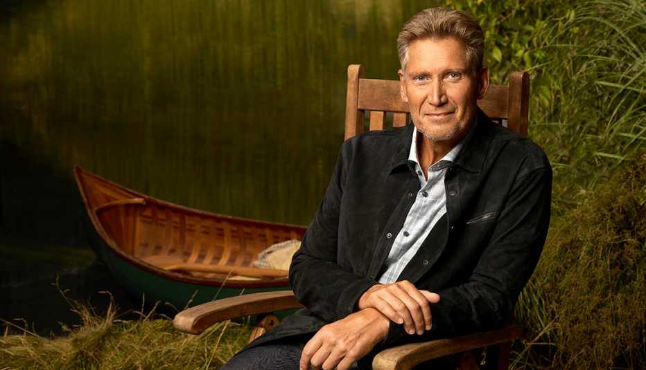 the golden bachelor gerry turner sitting in a wooden chair
