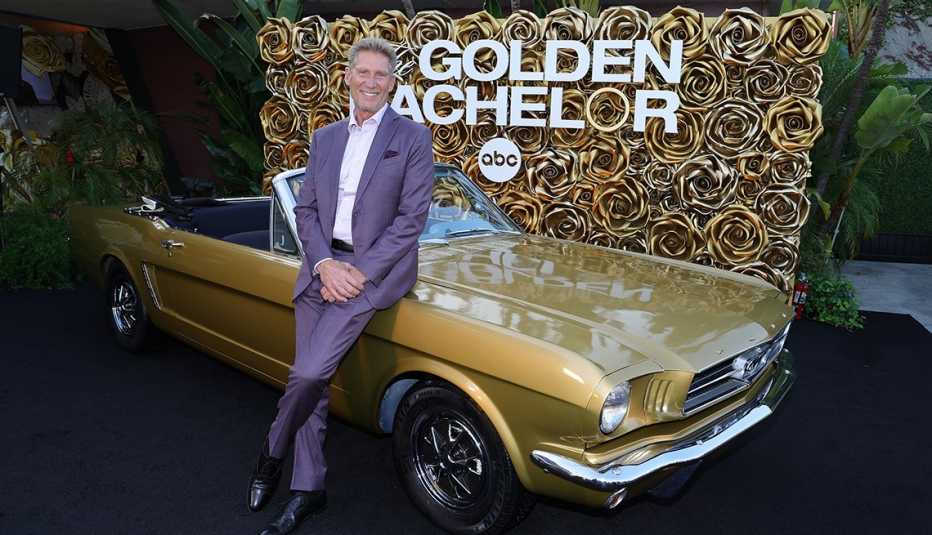 gerry turner stands in front of a convertible at mel's drive in
