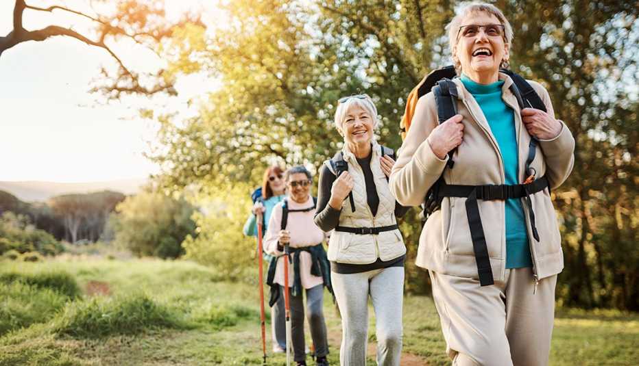 four women out for a hike with the sun setting