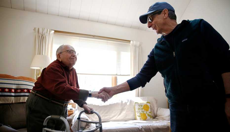 Two men shake hands
