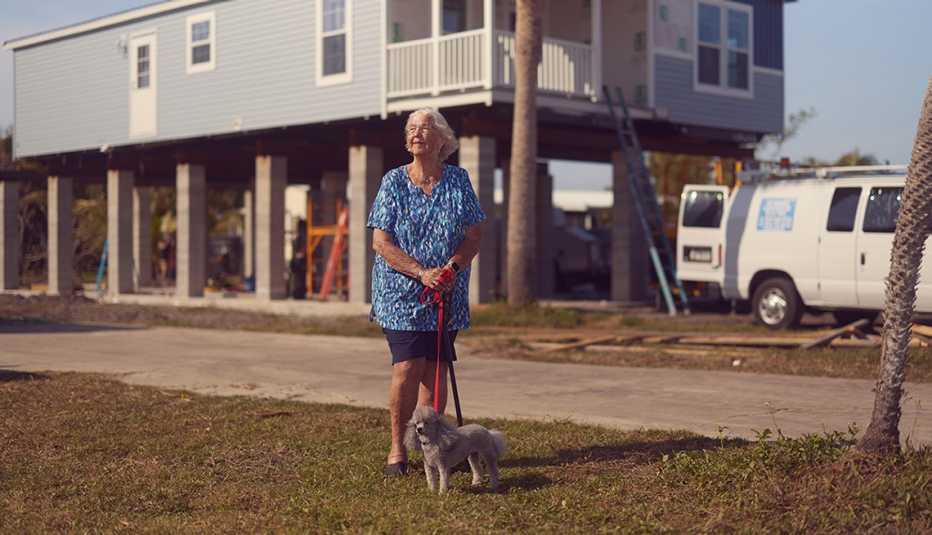 a woman stands with her dog