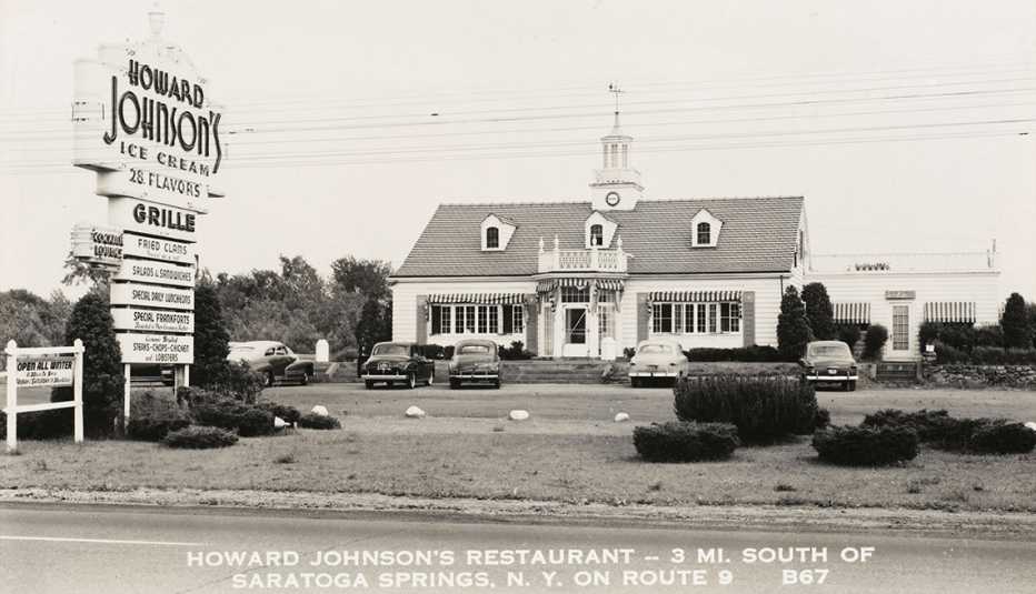 black and white historical photo of a howard johnsons restaurant and its large sign in front a historical photos of a howard johnsons