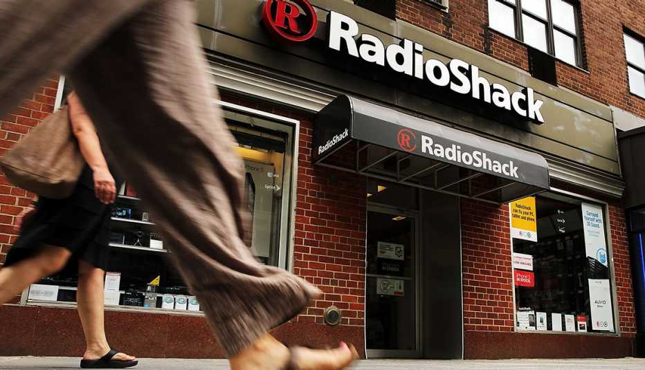 close up shot from the group of peoples legs moving past a radio shack storefront on a city sidewalk close up shot from the group of peoples legs moving past a radio shack storefront on a city sidewalk