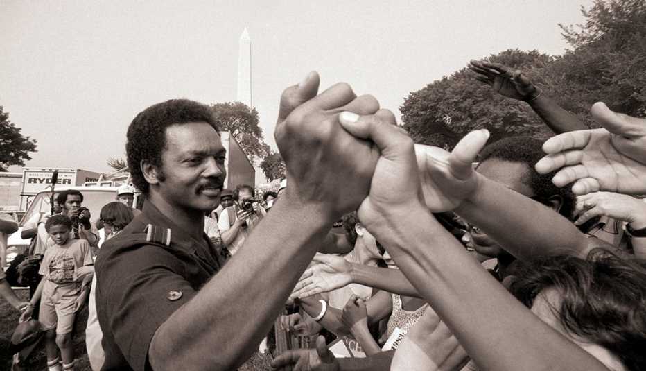 Rev. Jesse Jackson shakes hands at the 20th anniversary commemoration of the Martin Luther King, Jr.'s Freedom March, also known as the "March on Washington". reverend jesse jackson at the twentieth anniversary of martin luther kings freedom march on washington