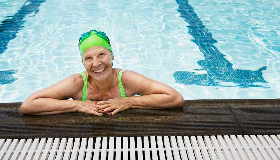 smiling woman at the edge of a swimming pool