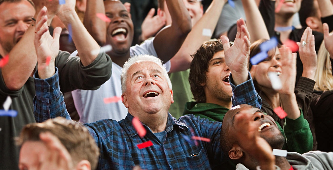 Mature adults cheer in a cowd 