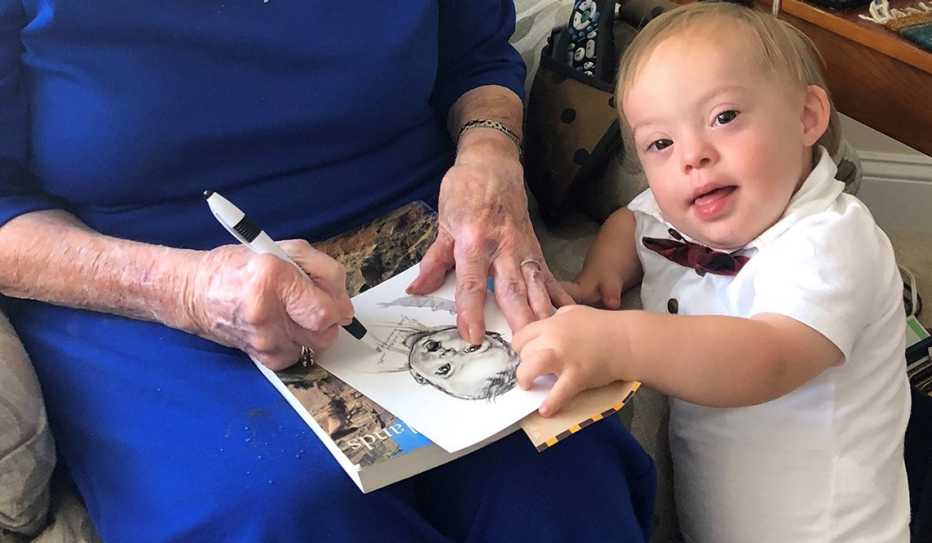 Newest Gerber Baby looks on as original Gerber Baby signs photo of herself. Newest Gerber Baby looks on as original Gerber Baby signs photo of herself.