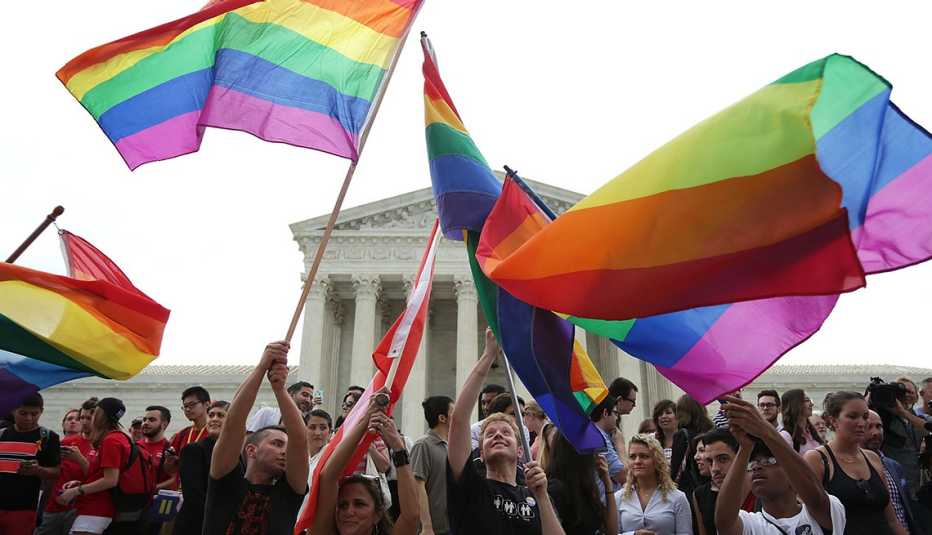 People wave flags outside of the supreme court
