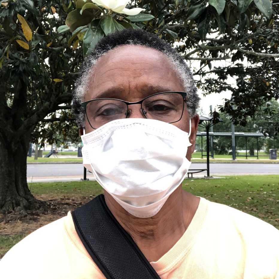 close up portrait of freddye hill wearing a covid face mask outdoors in a park