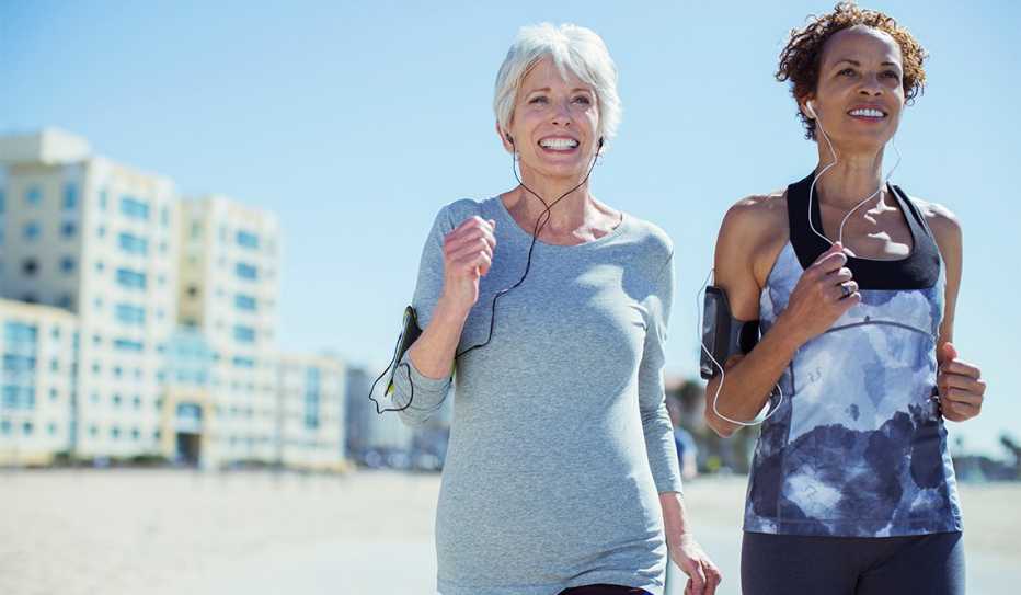 Two women running while listening to podcasts Two women running while listening to podcasts