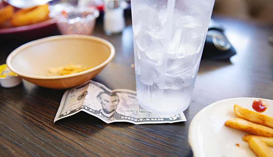 a tip left under a glass of water on a table top