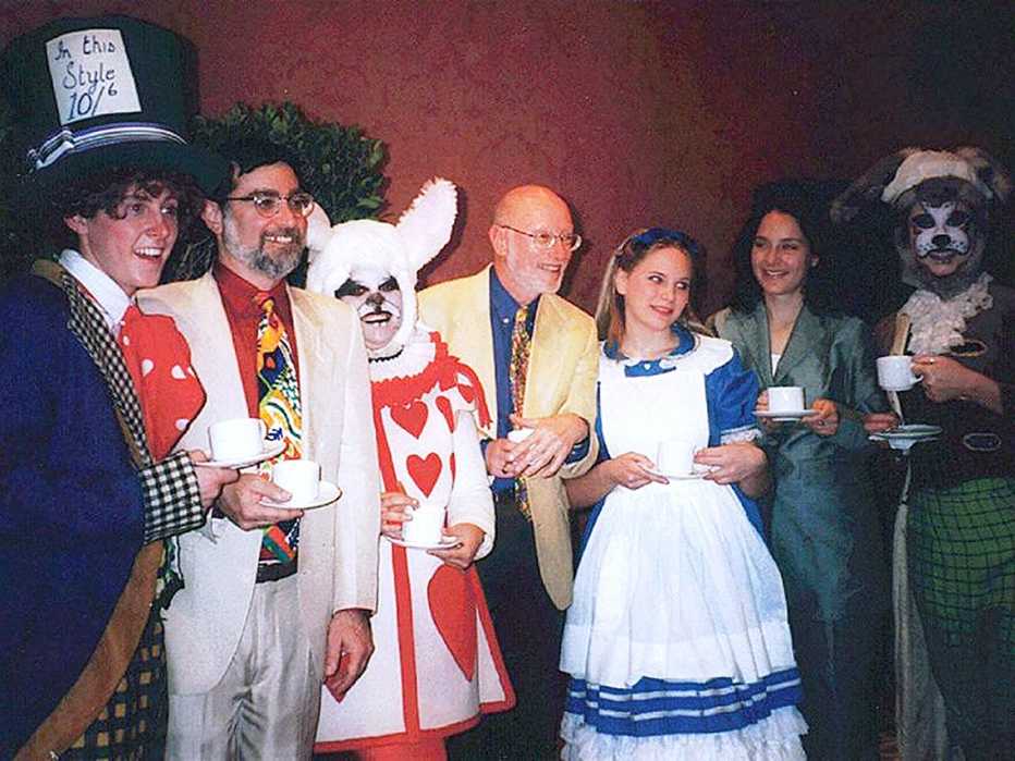 a group of seven people wearing alice in wonderland costumes a group of seven people wearing alice in wonderland costumes