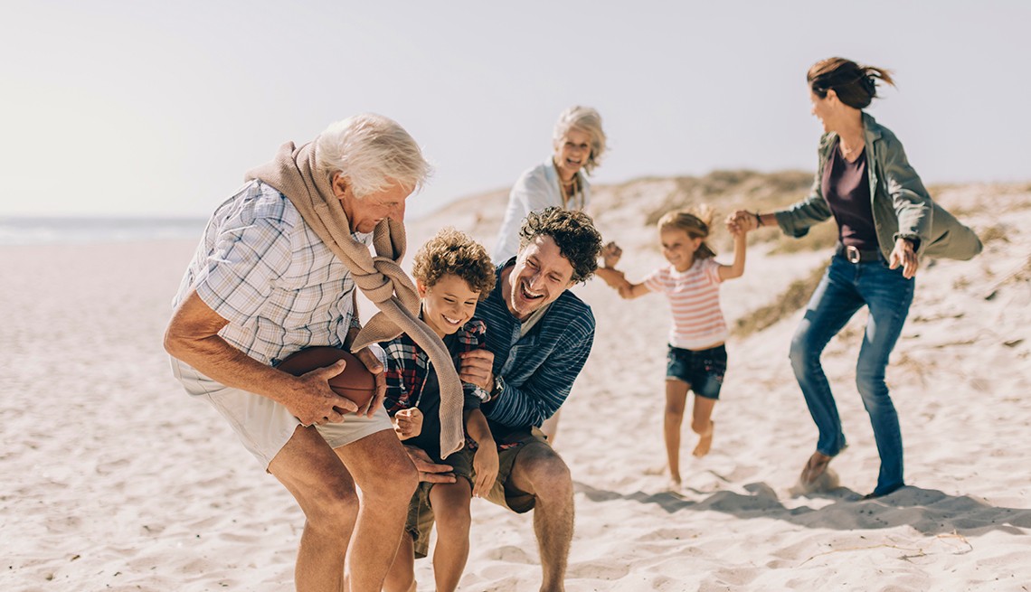 multi-generational family playing on the beach