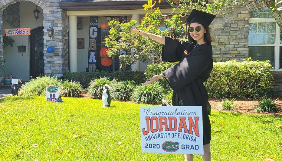 Jordan Kriseman poses in her front yard wearing her cap and gown