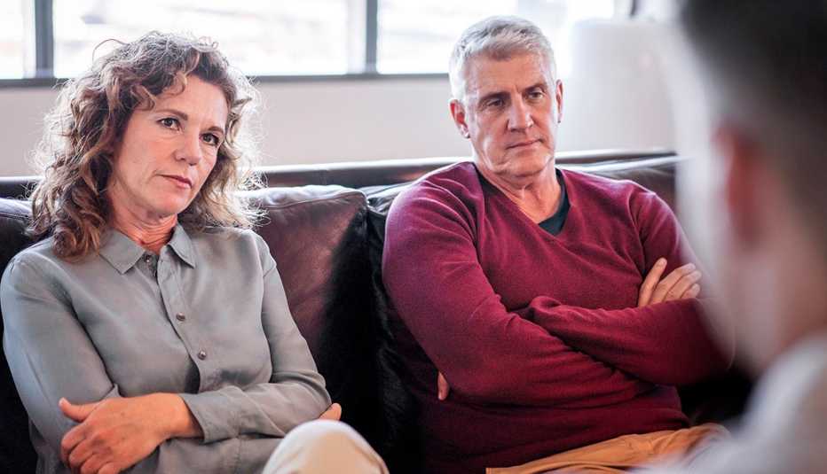  couple therapy. Male mental health professional is discussing with man and woman. They are wearing casuals. Mature couple having problems in a marriage.