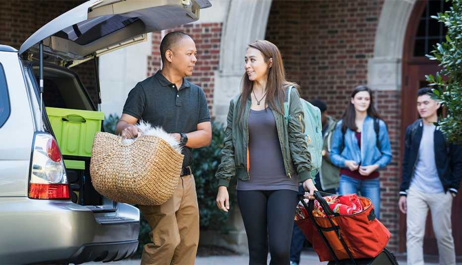 Father helping daughter moving to college dormitory