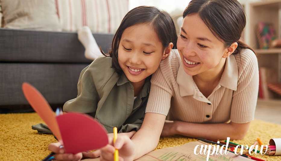 A mother and daughter making a handwritten Valentines Day cardq