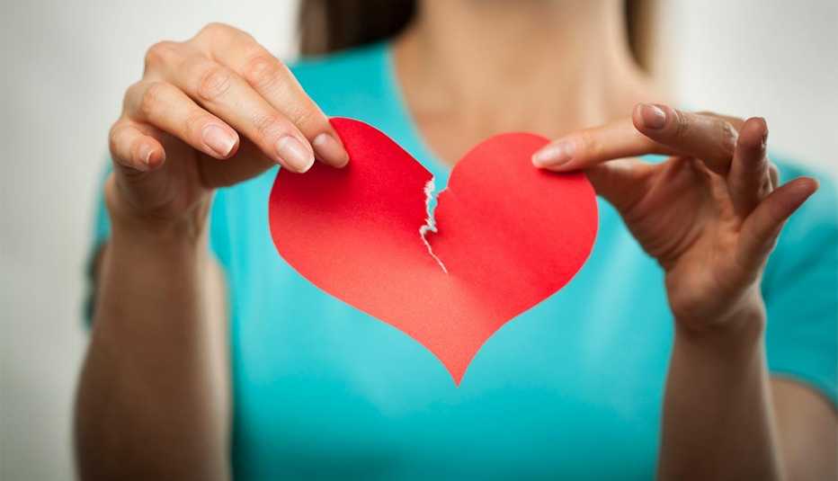 Woman tearing red paper heart, Reasons to breakup dating relationship Woman tearing red paper heart, Reasons to breakup dating relationship