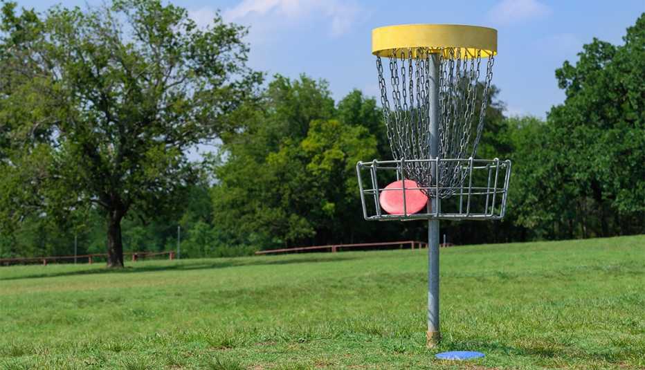 Disc golf hole basket in a park Disc golf hole basket in a park