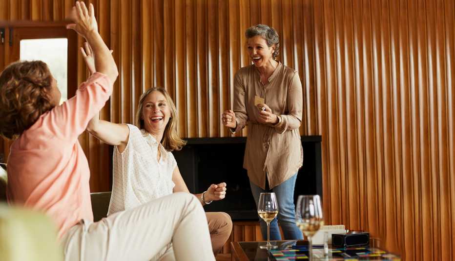 Cheerful friends enjoying indoor games at home