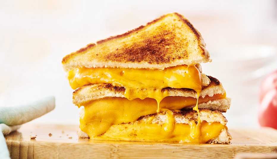 a grilled cheese sandwich on a cutting board