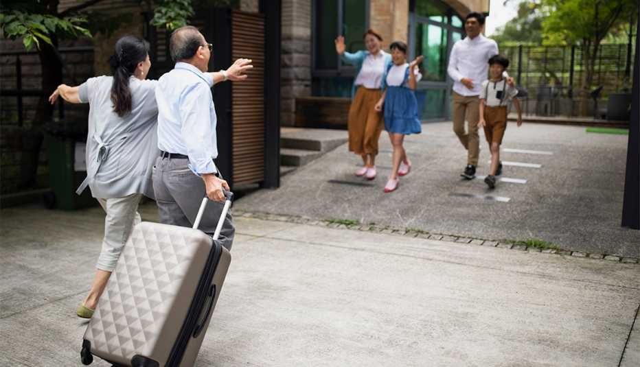 Family welcoming grandparents at the doorway