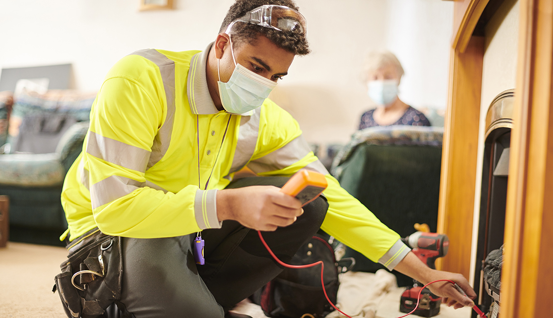 Repairman wearing face mask in home