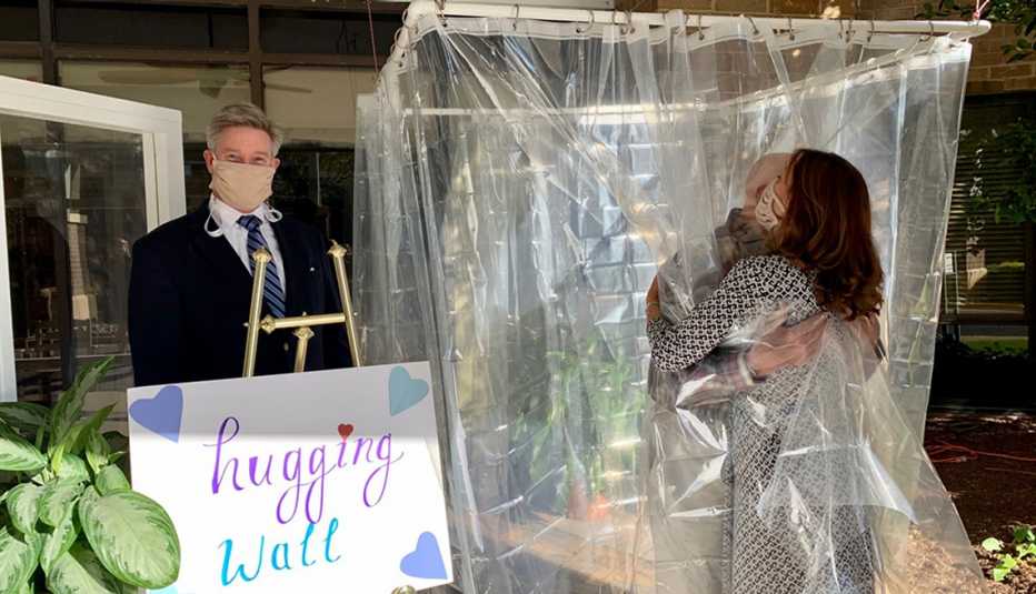 Dr. David Via and a family friend at one of our Hugging Walls.  Ben Unkle is standing next to to the Hugging Wall.
