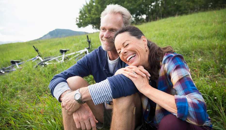 A couple embraces on a field