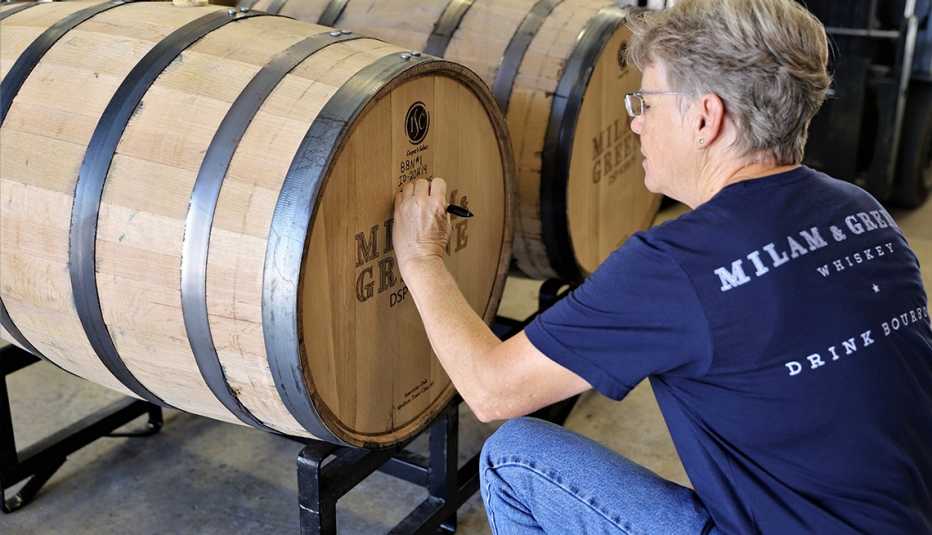 Marlene Holmes writing on a barrel