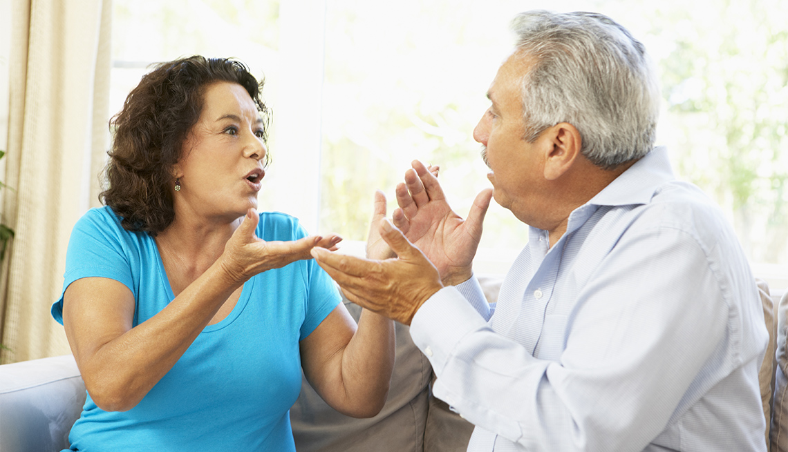 couple sitting on a couch having an argument