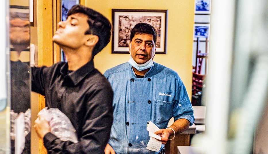 restauranteur navjot arora and one of his staff works in the kitchen