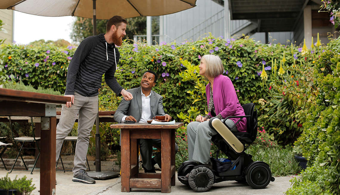 A woman uses a Whill Model Ci mobility chair