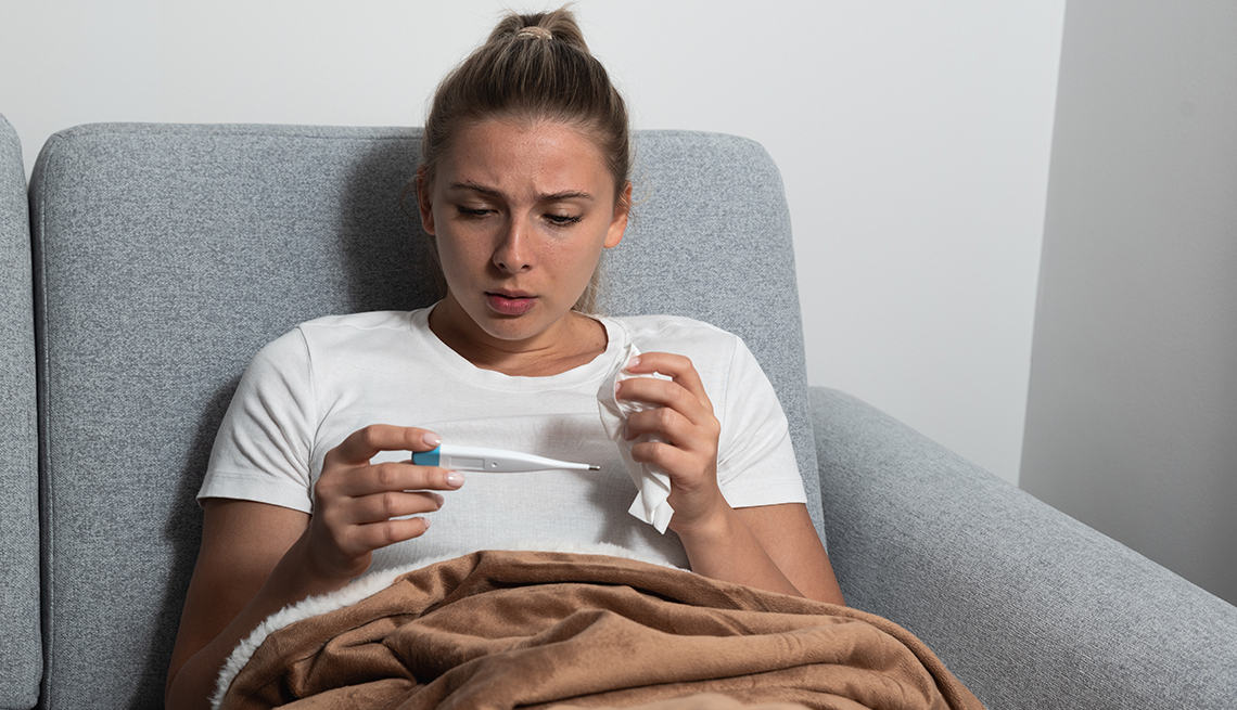 Young woman checking temperature