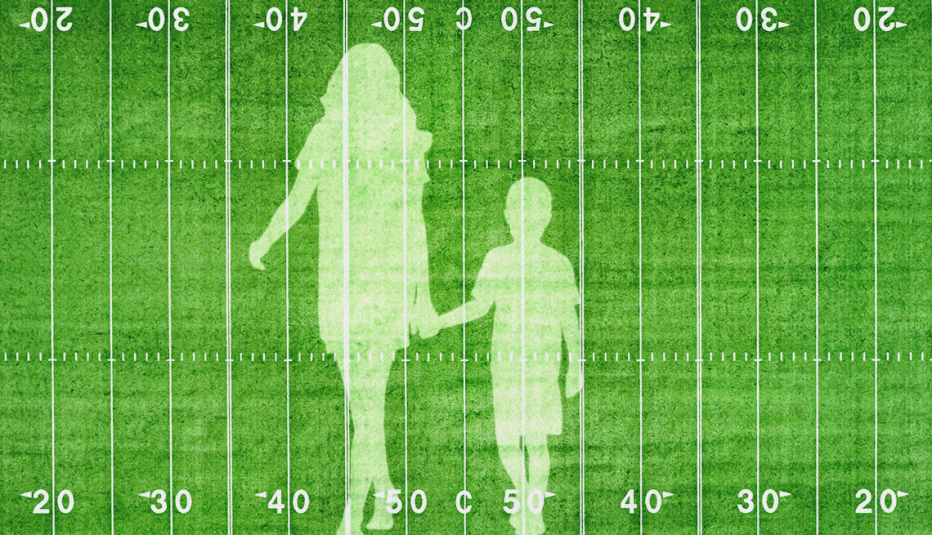 silhouettes of a mother and son on football gridiron