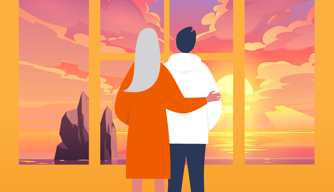 Mother and child looking at a sunset over the water