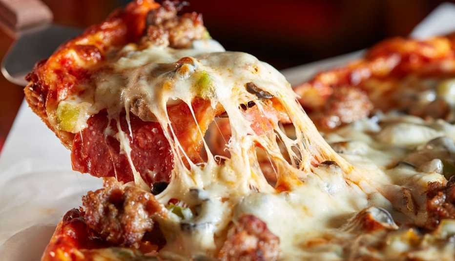 a melty and cheesy piece of pizza a melty and cheesy piece of pizza