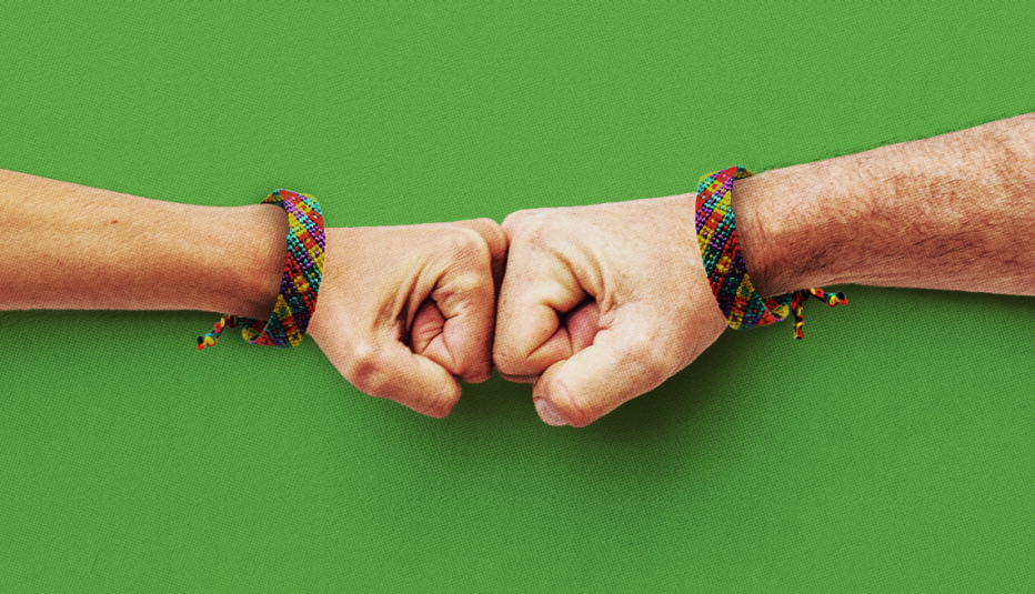 two fists bump on a green field