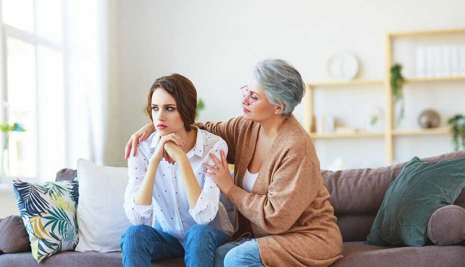 mother comforting teen daughter who appears stressed