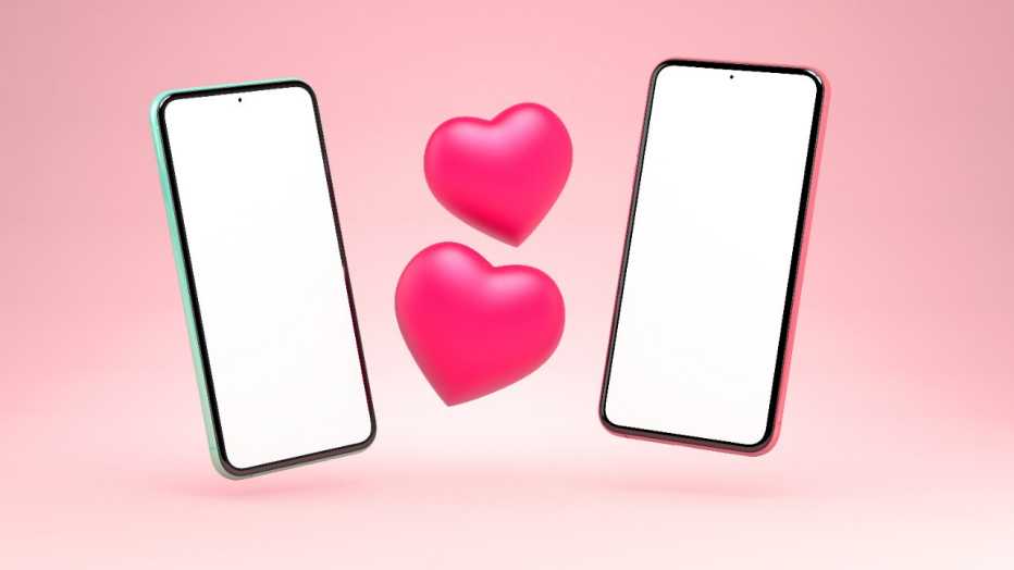 Two phones with two hearts in the middle on a pink background
