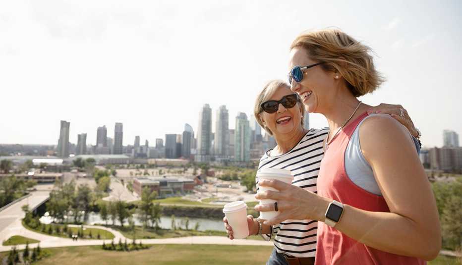 a smiling mother and daughter walking together